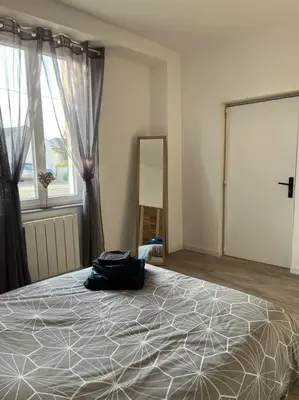 Un ou plusieurs lits dans un hébergement de l'établissement Appartement Centre de Guécélard