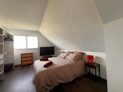 Un ou plusieurs lits dans un hébergement de l'établissement Maison chaleureuse tout confort