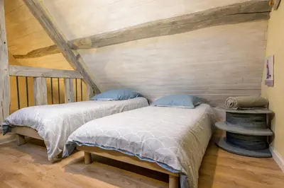 Un ou plusieurs lits dans un hébergement de l'établissement Gîte Les Toisnières