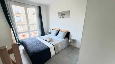 Un ou plusieurs lits dans un hébergement de l'établissement Appartement Duplex Cosy avec place de parking privée
