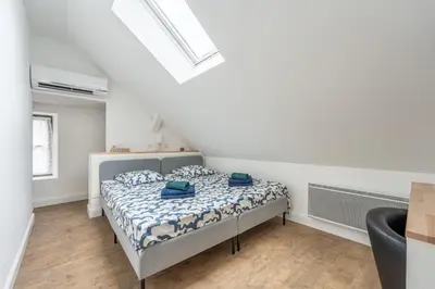 Un ou plusieurs lits dans un hébergement de l'établissement Duplex et Studio Saint Martin Le Beau