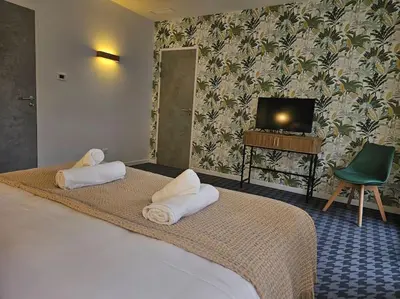 Un ou plusieurs lits dans un hébergement de l'établissement Le Petit Versailles Loire Tours