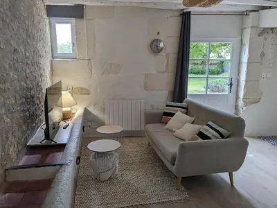 Coin salon dans l'établissement Maison dans belle longère - La Serrerie