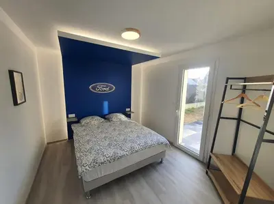 Un ou plusieurs lits dans un hébergement de l'établissement Maison à thème le Mans 66