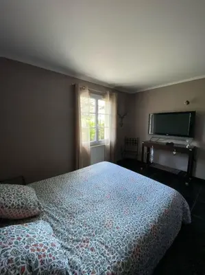 Un ou plusieurs lits dans un hébergement de l'établissement Maison chaleureuse aux portes de Tours.
