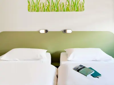 Un ou plusieurs lits dans un hébergement de l'établissement Ibis Budget Angers Parc des Expositions
