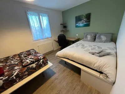 Un ou plusieurs lits dans un hébergement de l'établissement Maison belle capacité Avoine