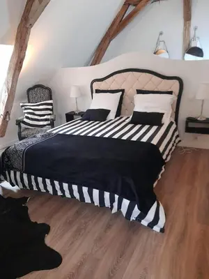 Un ou plusieurs lits dans un hébergement de l'établissement chambre d'hôtes dans un moulin du 16ème