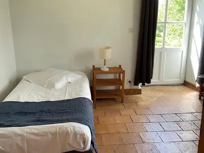 Un ou plusieurs lits dans un hébergement de l'établissement Spacieuse maison au bord de la rivière, proche du Mans, avec équipements modernes, idéale pour familles - FR-1-410-440
