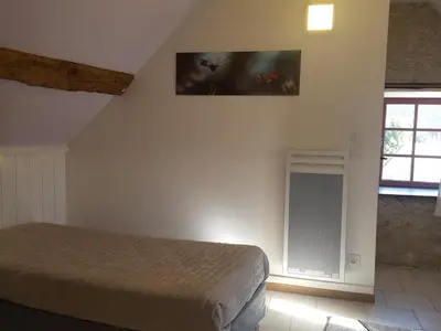 Un ou plusieurs lits dans un hébergement de l'établissement Gîte 18ème avec jardin, jeux, et ateliers cuisine près de l'Abbaye de Pontlevoy. - FR-1-491-349