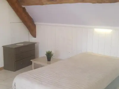 Un ou plusieurs lits dans un hébergement de l'établissement Gîte 18ème avec jardin, jeux, et ateliers cuisine près de l'Abbaye de Pontlevoy. - FR-1-491-349