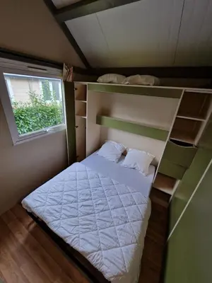 Un ou plusieurs lits dans un hébergement de l'établissement Village Vacances Les Fontenils