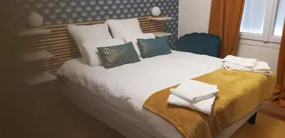 Un ou plusieurs lits dans un hébergement de l'établissement Maison cosy citadine