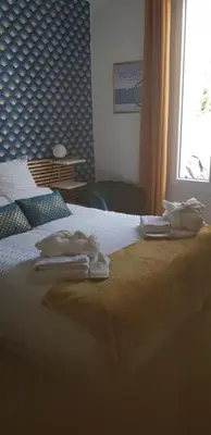 Un ou plusieurs lits dans un hébergement de l'établissement Maison cosy citadine