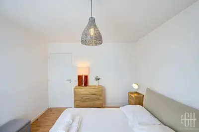Un ou plusieurs lits dans un hébergement de l'établissement Le Lilas - 2 chambres - parking