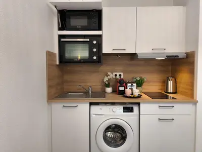 Cuisine ou kitchenette dans l'établissement Magnifique Studio Douillet