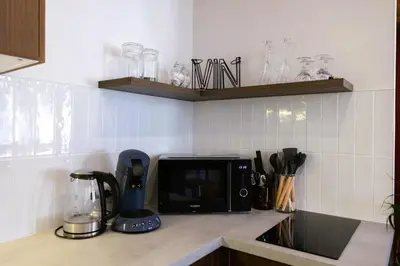 Cuisine ou kitchenette dans l'établissement Le Petit Domaine - Centre Ville