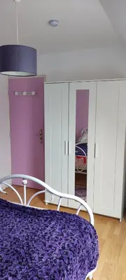 Un ou plusieurs lits dans un hébergement de l'établissement Chambre en maison chez l habitant