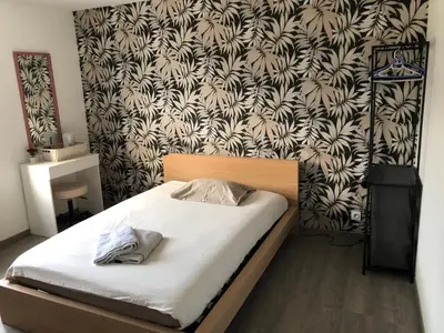 Un ou plusieurs lits dans un hébergement de l'établissement Grande chambre côté jardin