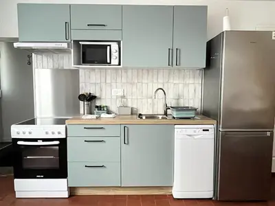Cuisine ou kitchenette dans l'établissement Gîte cosy tout confort - Le palmier