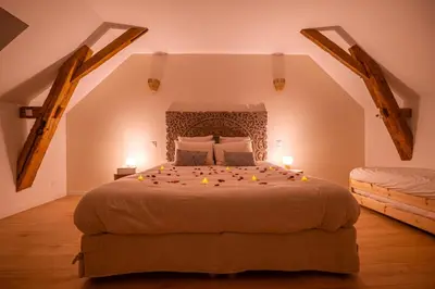 Un ou plusieurs lits dans un hébergement de l'établissement La Grange Clyna - Love Room