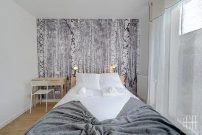 Un ou plusieurs lits dans un hébergement de l'établissement Maison familiale 4 chambres avec jardin et parking