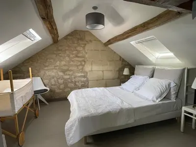 Un ou plusieurs lits dans un hébergement de l'établissement Charmante maison jardin centre