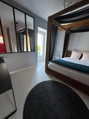 Un ou plusieurs lits dans un hébergement de l'établissement Kimy Villa Lunoterie Futuroscope Piscine et Spa