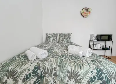 Un ou plusieurs lits dans un hébergement de l'établissement Studio lumineux avec jardin commun à Tours