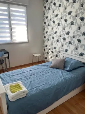 Un ou plusieurs lits dans un hébergement de l'établissement location Chambres proximite du circuit 24 h