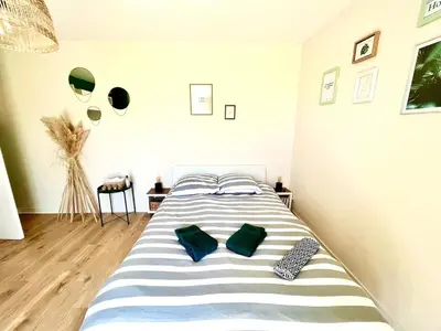 Un ou plusieurs lits dans un hébergement de l'établissement Cocooning appartement