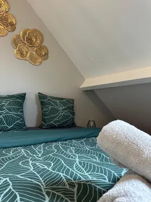 Un ou plusieurs lits dans un hébergement de l'établissement Gîte de 7 chambres à 10 min des 24H du Mans