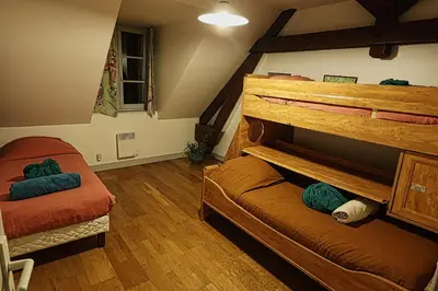 Un ou plusieurs lits dans un hébergement de l'établissement Gîte - Gué Léger - Nature & Spa - Jacuzzi, Sauna et Piscine chauffée - 15 pers