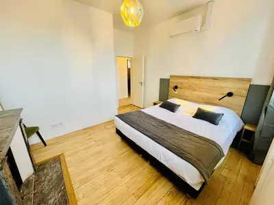 Un ou plusieurs lits dans un hébergement de l'établissement Appartement spacieux & familial, climatisation, hypercentre de Tours, le Belvédère