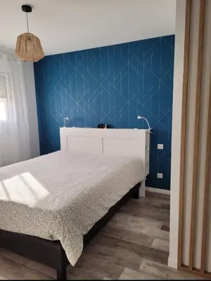 Un ou plusieurs lits dans un hébergement de l'établissement Chambre à 20min du Circuit