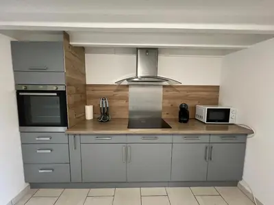 Cuisine ou kitchenette dans l'établissement La citadine - Confort espace et nature