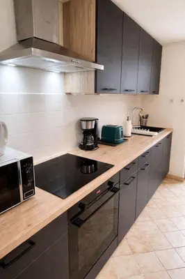 Cuisine ou kitchenette dans l'établissement Les 2 Tilleuls - Maison de charme avec jardin