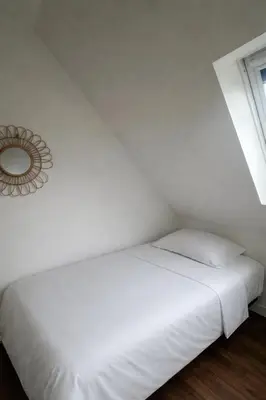 Un ou plusieurs lits dans un hébergement de l'établissement Charmant appartement au cœur de ville