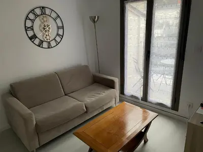 Coin salon dans l'établissement Appartement terrasse en ville