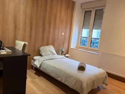 Un ou plusieurs lits dans un hébergement de l'établissement Hôtel Le Normandie