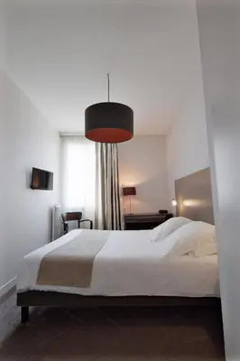 Un ou plusieurs lits dans un hébergement de l'établissement Hôtel Ronsard