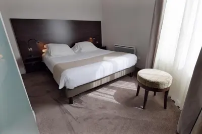 Un ou plusieurs lits dans un hébergement de l'établissement Hôtel Ronsard