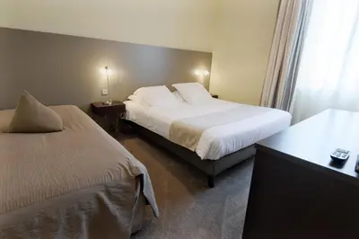 Un ou plusieurs lits dans un hébergement de l'établissement Hôtel Ronsard