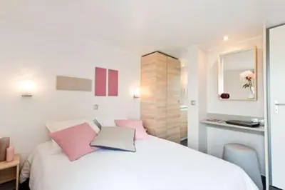 Un ou plusieurs lits dans un hébergement de l'établissement Résidence de vacances Villa Cottage