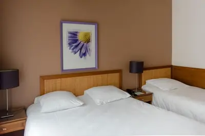 Un ou plusieurs lits dans un hébergement de l'établissement Cit'Hotel Criden