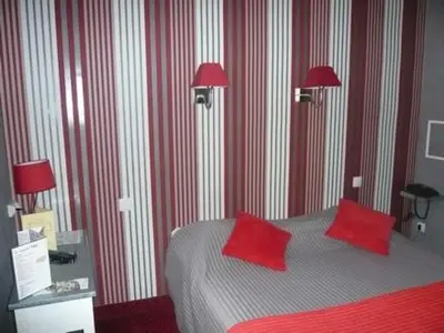 Un ou plusieurs lits dans un hébergement de l'établissement Cit'Hôtel - Restaurant Saint Jacques