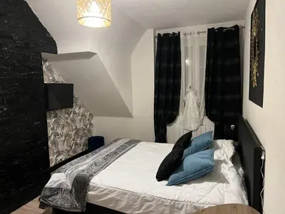 Un ou plusieurs lits dans un hébergement de l'établissement Gîtes et Chambres des Coteaux