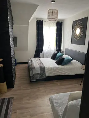 Un ou plusieurs lits dans un hébergement de l'établissement Gîtes et Chambres des Coteaux