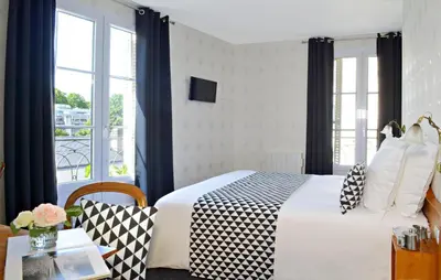 Un ou plusieurs lits dans un hébergement de l'établissement Hôtel Du Manoir