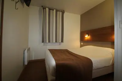 Un ou plusieurs lits dans un hébergement de l'établissement Fasthotel Tours Sud